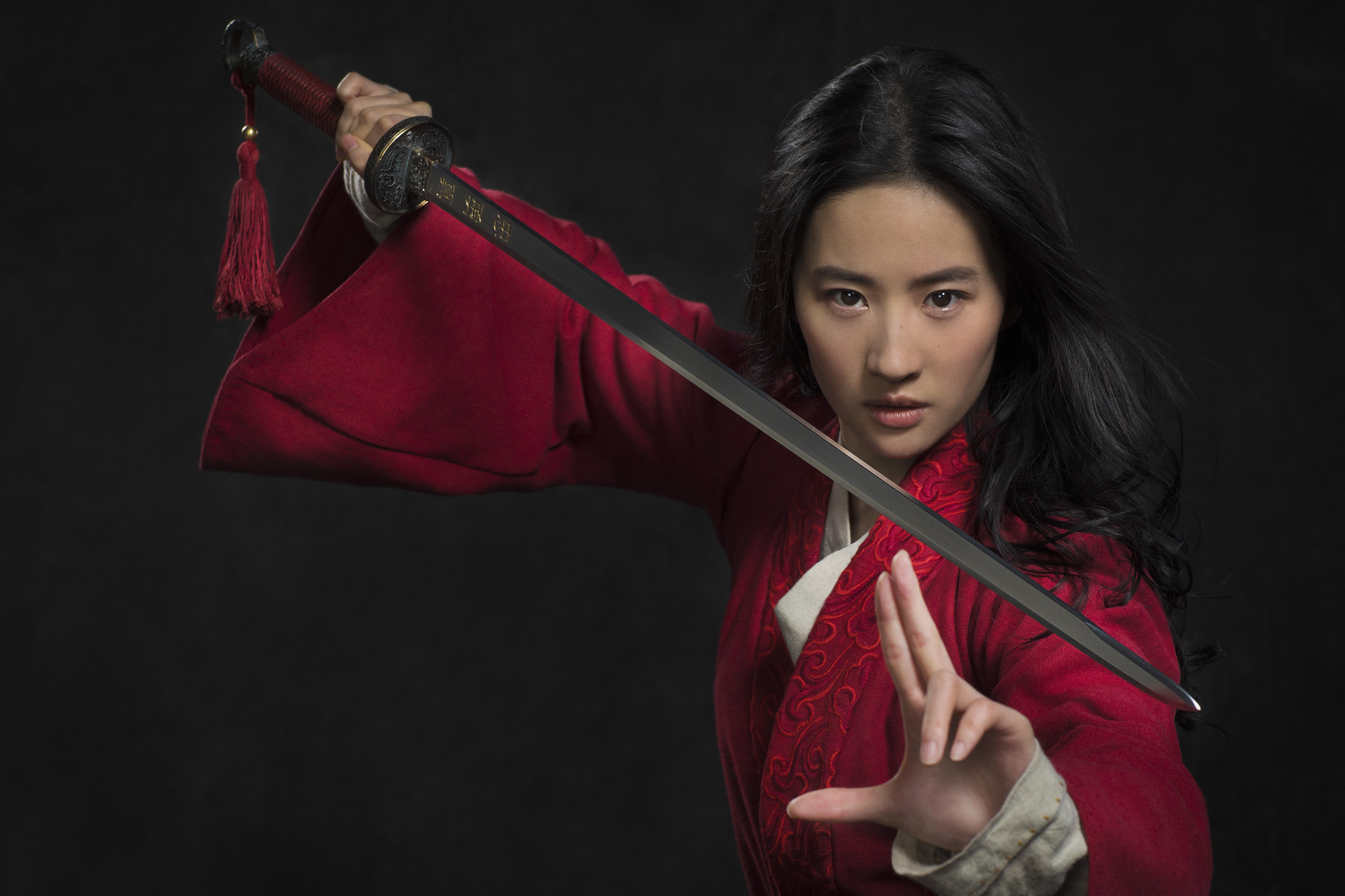 Mulan (Yifei Liu) holds a sword in a scene of Disney's live action remake of “Mulan.” The film is facing calls for a boycott after the company thanked government entities in Xinjiang, a Chinese region where authorities are accused of suppressing ethnic minorities.