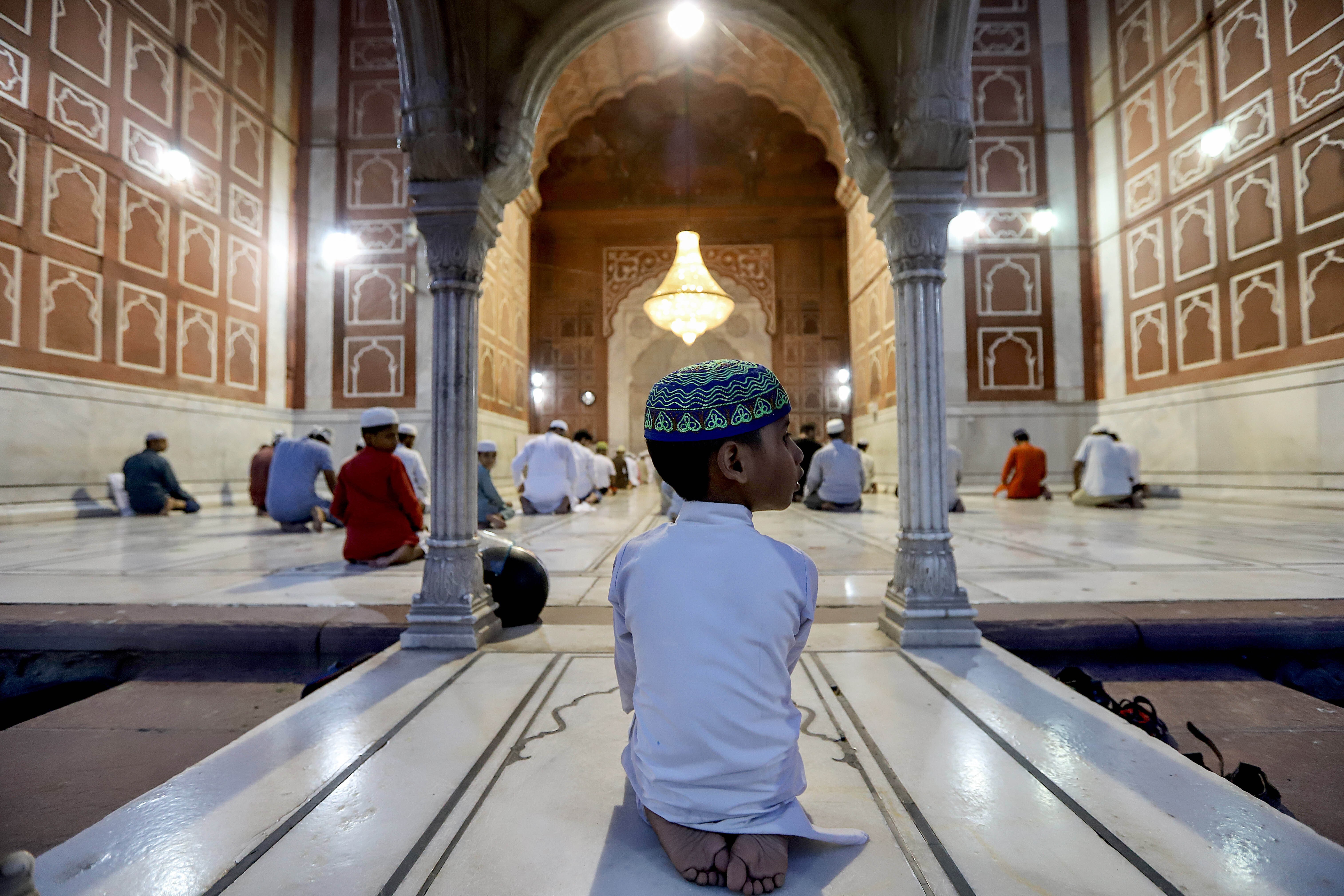 Devotees pray during the religious festival of Eid ul-Fitr in Jama Masjid, Delhi, India. Many ceremonies have been cancelled across the country due to the coronavirus pandemic. Photo: Amarjeet Kumar Singh