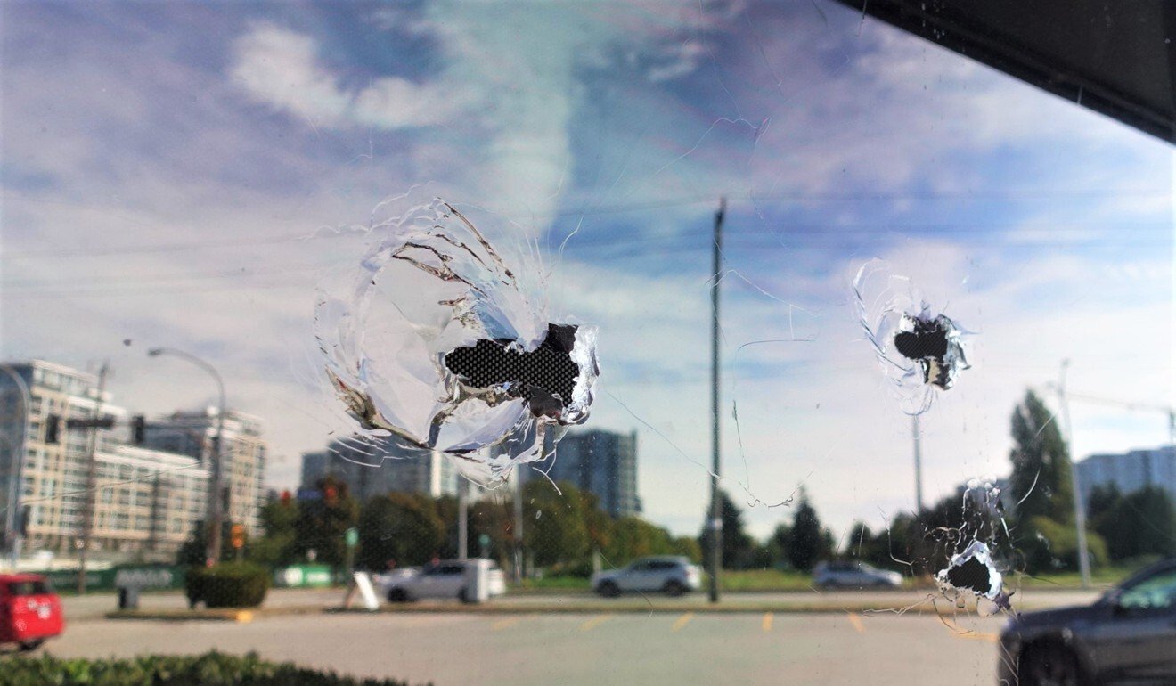 Bullet holes are seen in the window of the Manzo Itamae Japanese Restaurant in Richmond, BC, where accused money launderer Jian Jun Zhu was shot dead last week. Photo: Ian Young