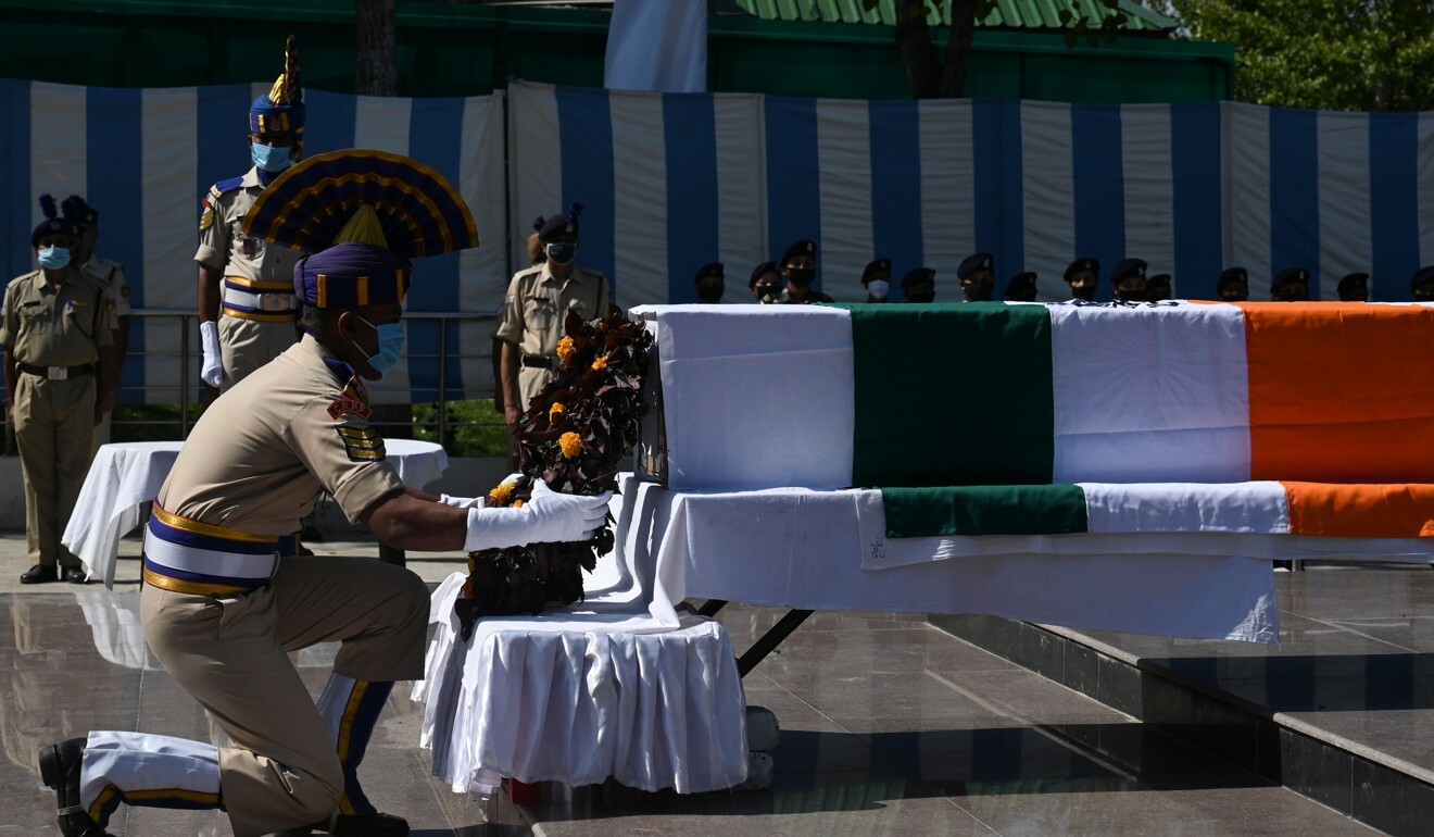 A member of the Indian Central Reserve Police Force lays a wreath on the coffin of a colleague killed by suspected militants in Srinagar, Kashmir. Photo: AFP