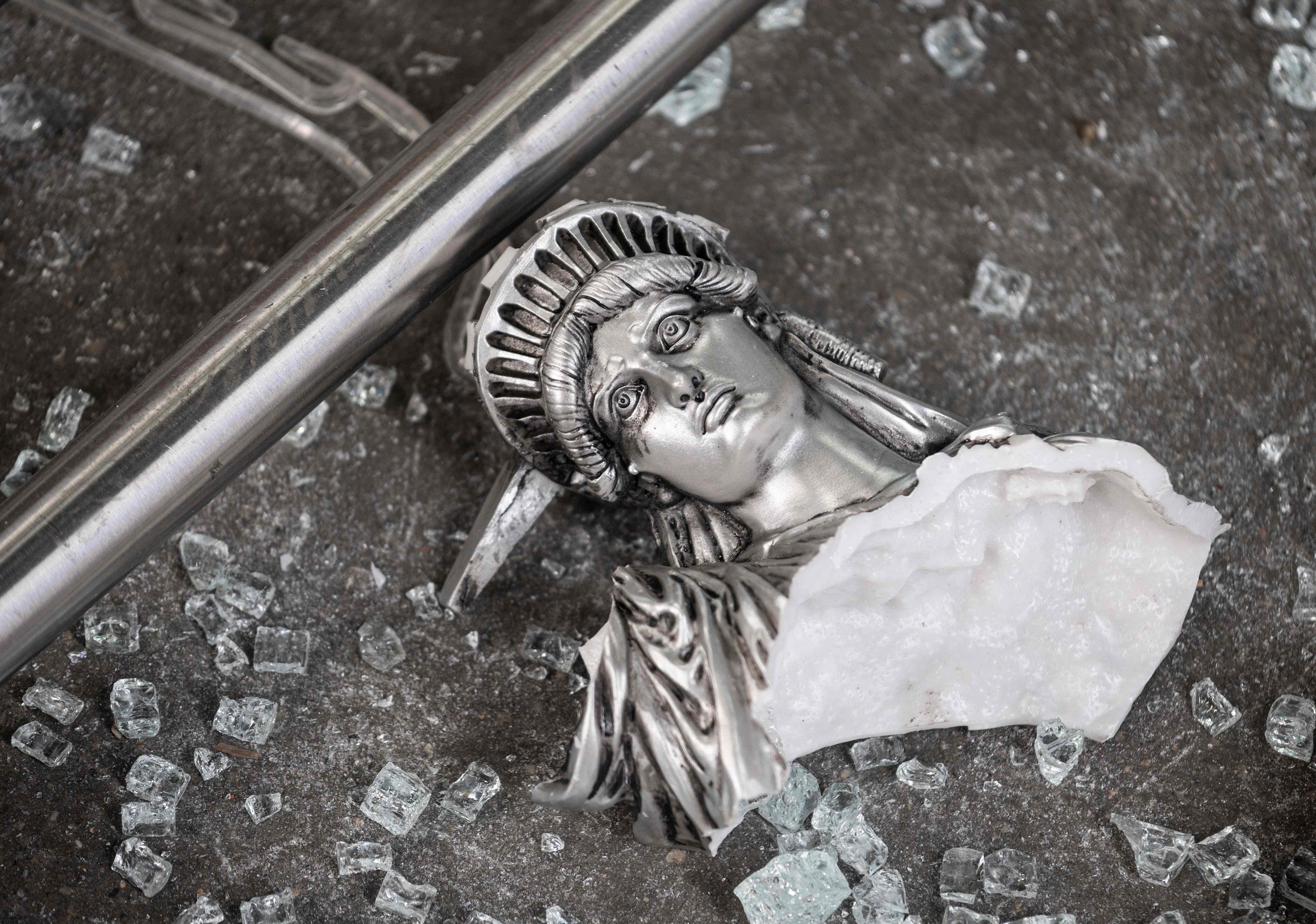 A broken Statue of Liberty figure is seen amid glass shards outside a looted souvenir shop in New York City, after a night of protests on June 2 over the death of George Floyd. Is the world seeing the end of the aura of American exceptionalism that has given the dollar Teflon-like resilience for most of the post-World War II era? Photo: AFP