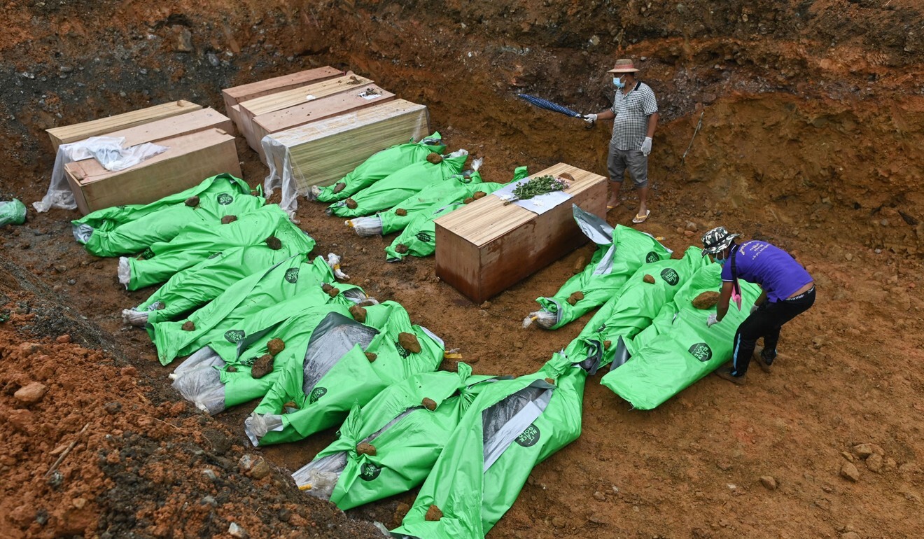 The bodies of miners in wooden coffins and wrapped in bags. Photo: AFP