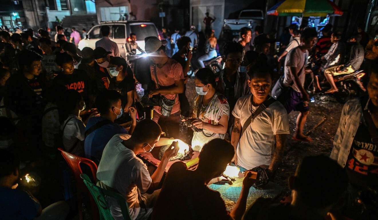 Miners offer jade for sale to brokers in a jade night market in Hpakant in Kachin state. Photo: AFP