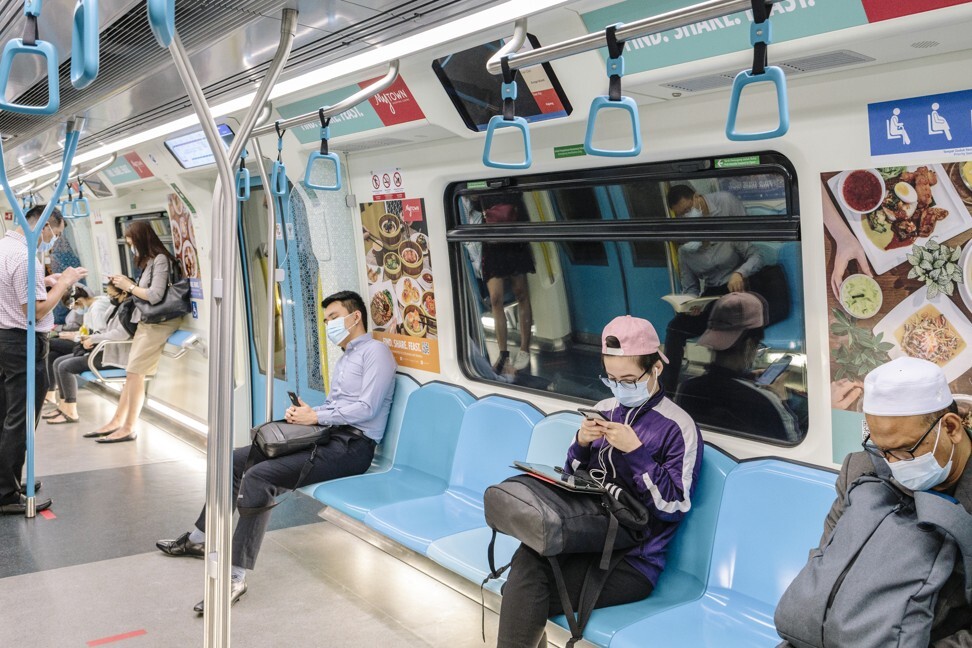 Passengers practise physical distancing on the train in Kuala Lumpur. Photo: Bloomberg