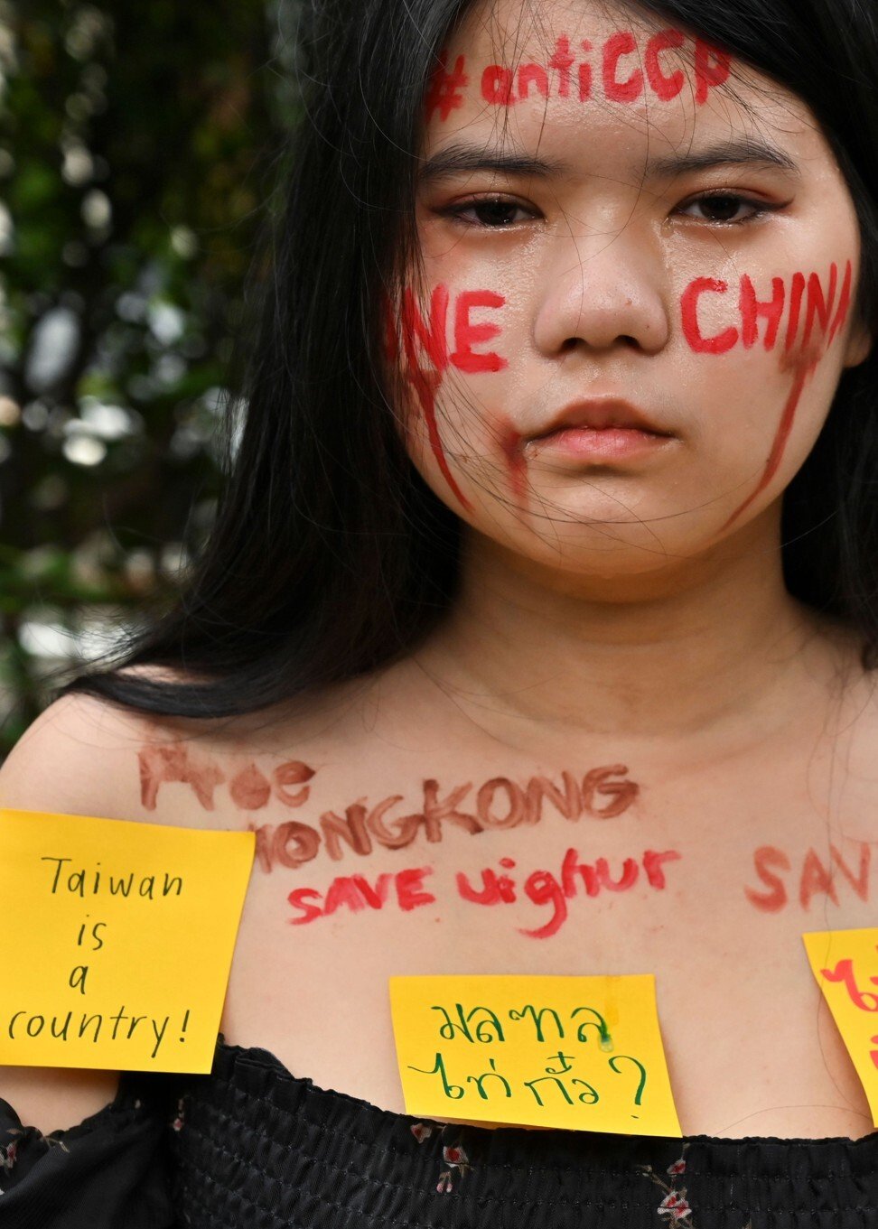 Thai university student Napassorn Saengduean takes part in a protest outside the Chinese embassy in Bangkok. Photo: AFP