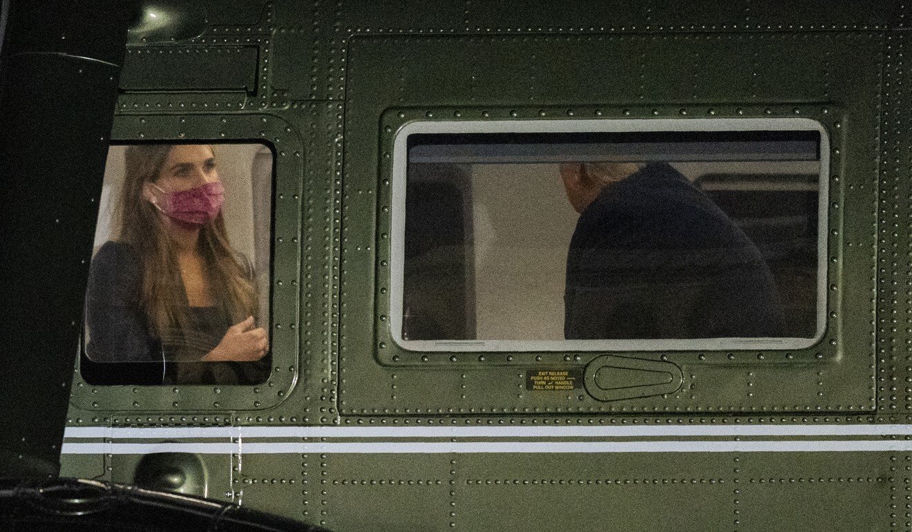 Hope Hicks (left) is seated across Donald Trump inside Marine One as it lands on the South Lawn at the White House on Monday. Photo: AP