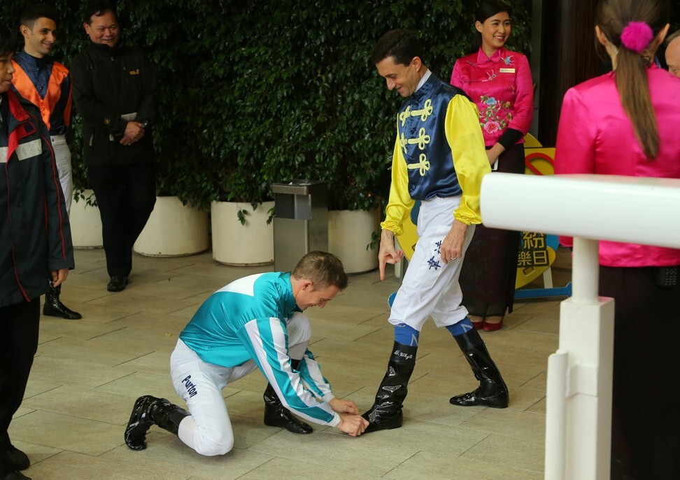 Zac Purton pretends to shine Douglas Whyte’s boots on his final day of riding in 2019.