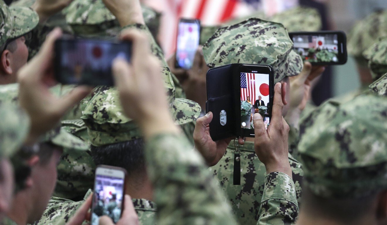 American military personnel take photos of US President Donald Trump and US First Lady Melania Trump aboard a helicopter carrier at the US naval base in Yokosuka, Kanagawa prefecture, Japan, on May 28, 2019. Photo: Bloomberg