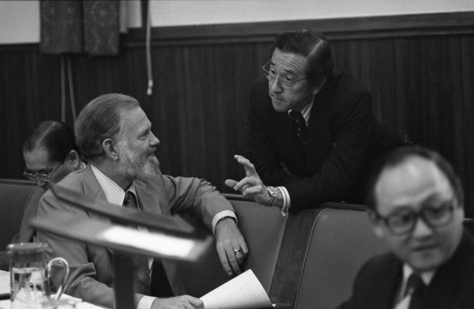 Legislative councillor Roger Lobo (centre) chats with secretary for housing Alan Scott during a Legislative Council session in November 1978 in colonial Hong Kong. Photo: SCMP