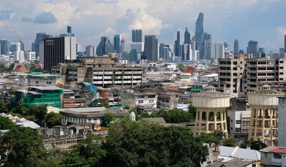 Modern skyscrapers dominate the skyline, with old low-rise buildings in the foreground, in a central area of Bangkok, near Baan Khrua. Photo: Tibor Krausz