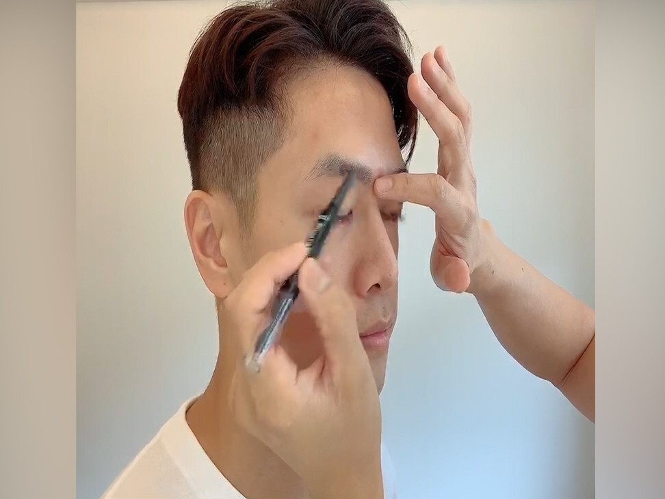 Alvin Goh uses an eyebrow pencil in the first step of his tutorial on men's make up.