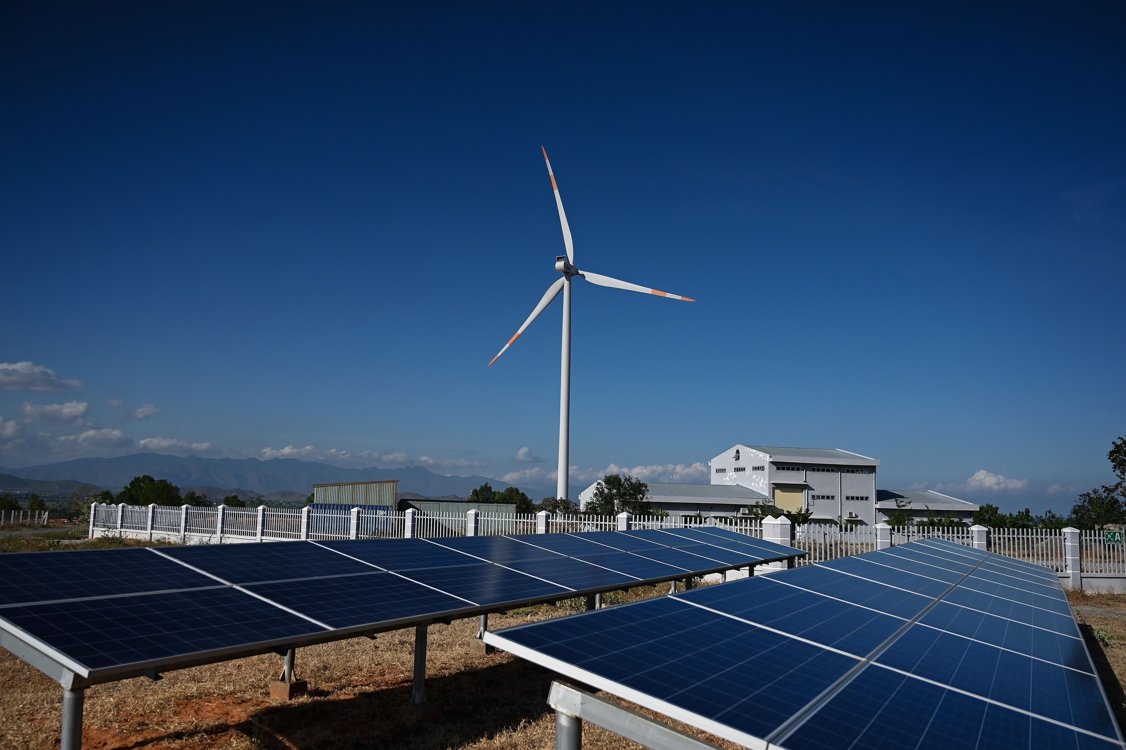 Solar panel installations and a wind turbine at the Phu Lac wind farm in southern Binh Thuan province in Vietnam on April 23, 2019. Vietnam has invested heavily in its solar capacity in recent years, making it one of the region’s leaders in renewable energy. Photo: AFP