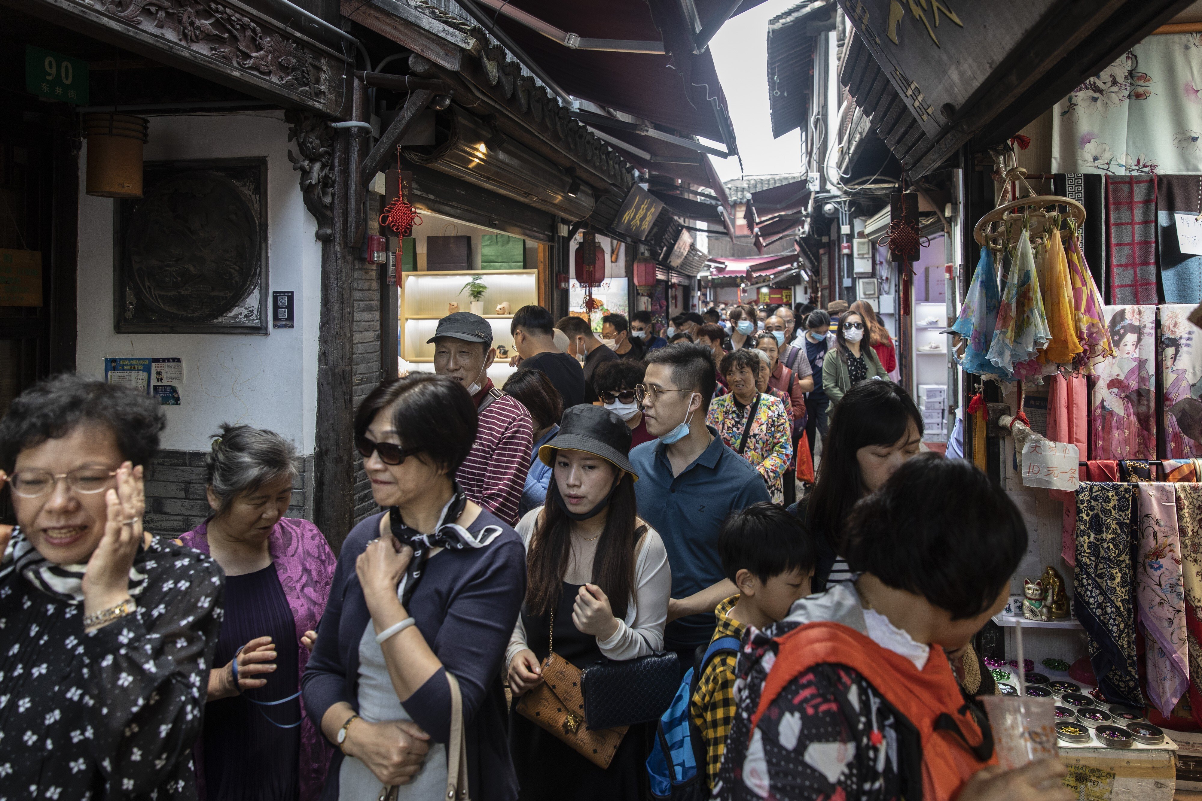 Visitors crowd onto a narrow alley in Zhujiajiao Water Town on the outskirts of Shanghai, China, on Monday, October 5, 2020. Photo: Bloomberg