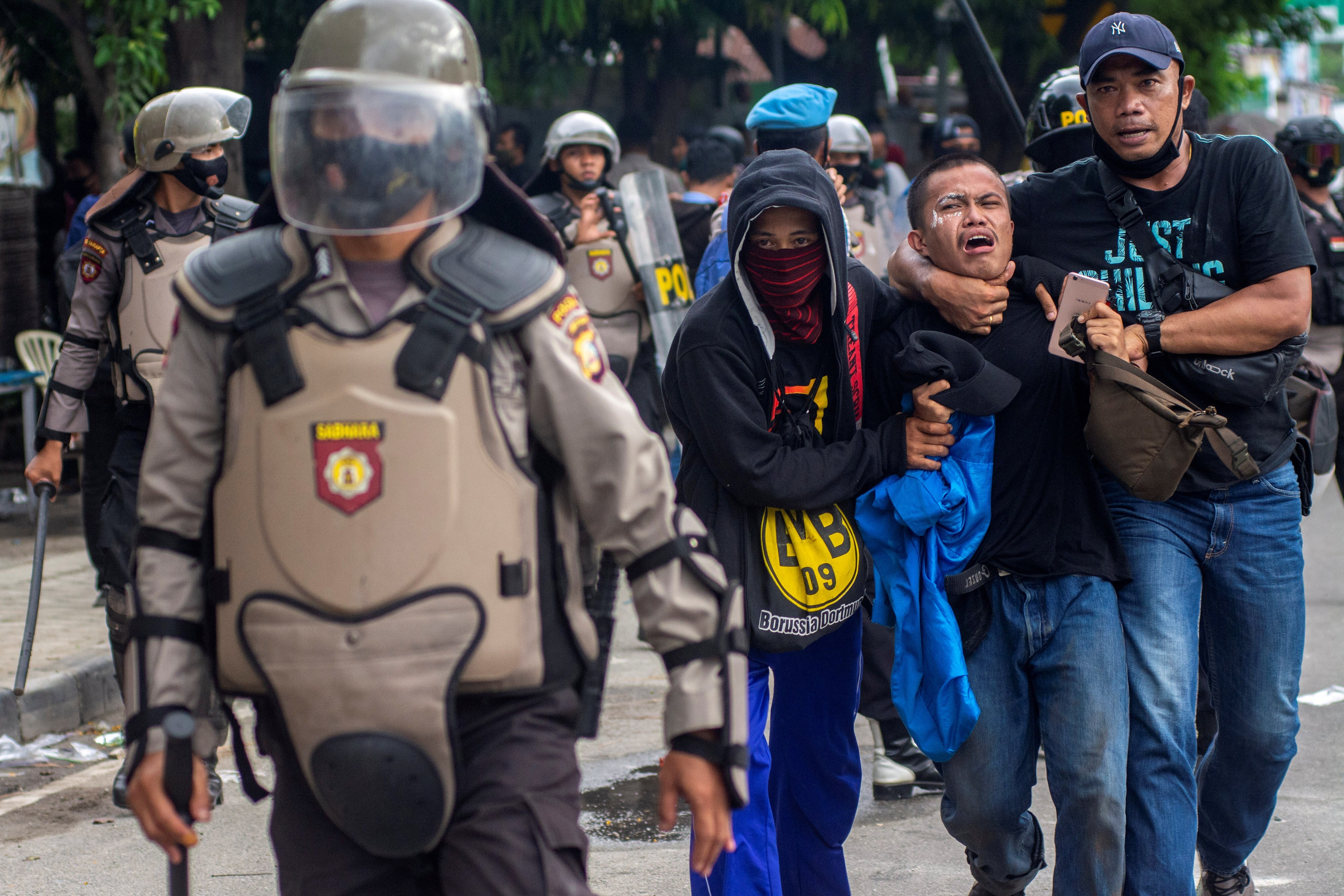 Plainclothes policemen detain a student protester in Palu, Central Sulawesi province. Photo: Antara Foto via Reuters