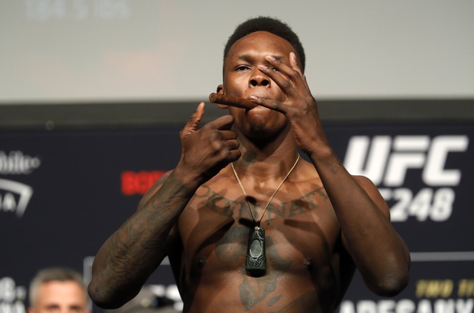 UFC middleweight champion Israel Adesanya, poses on the scale during a ceremonial weigh-in for UFC 248. Photo: AP