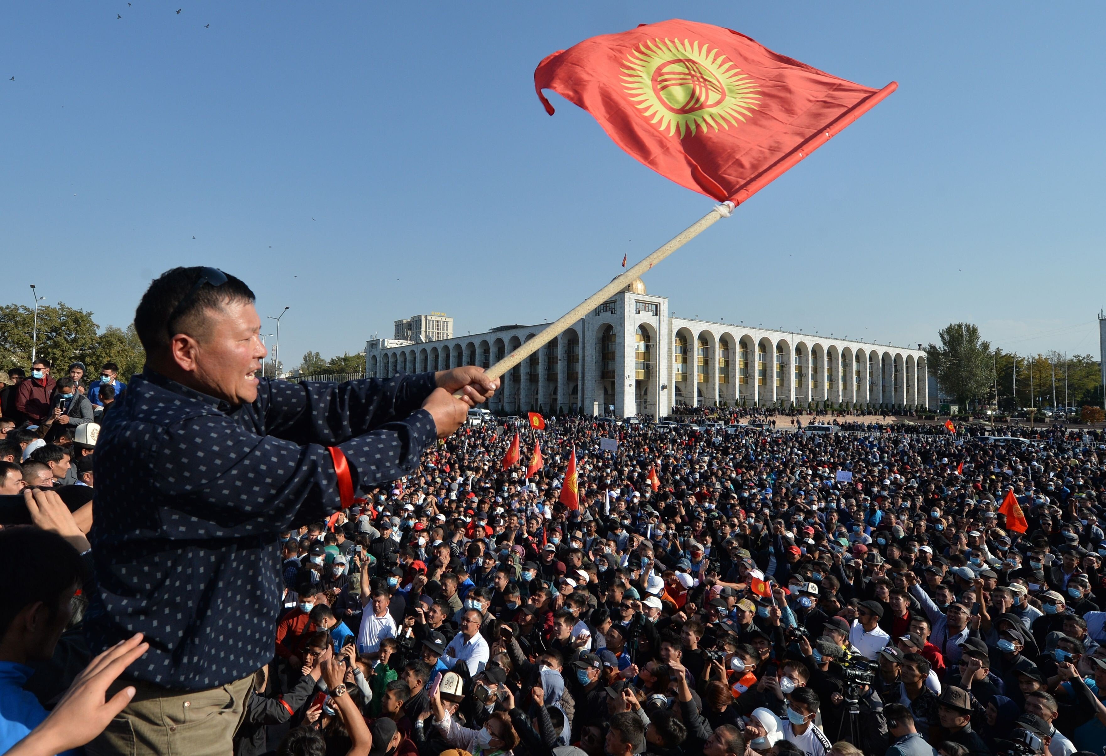 A protester waves a Kyrgyz flag during a rally against the results of a parliamentary vote in Bishkek, Kyrgyzstan, on October 5. Photo: AP