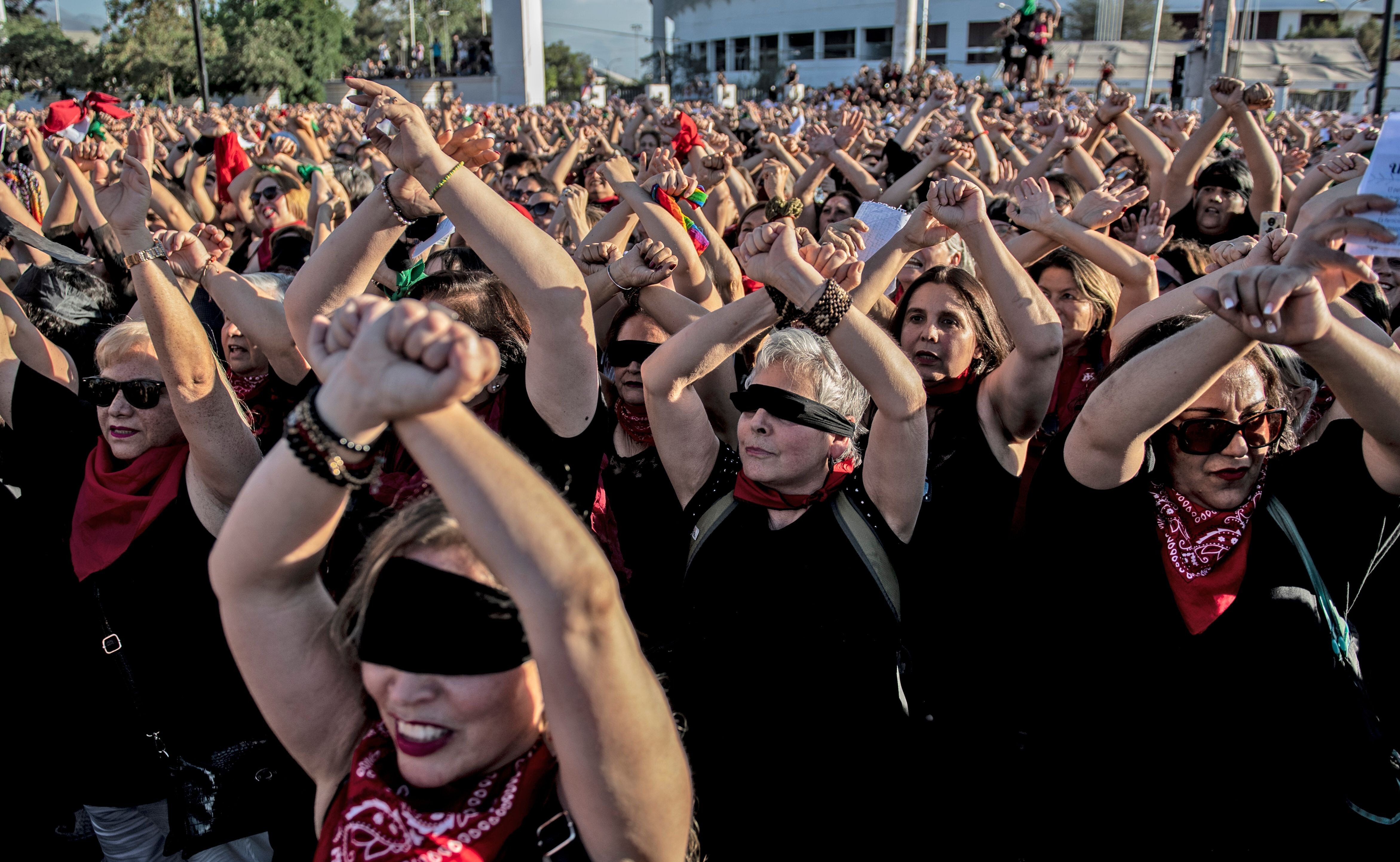 Thousands of women’s rights activists take part in a choreographed performance of the feminist song, “The rapist is you”, in Santiago, Chile on December 04, 2019. Photo: AFP via Getty Images