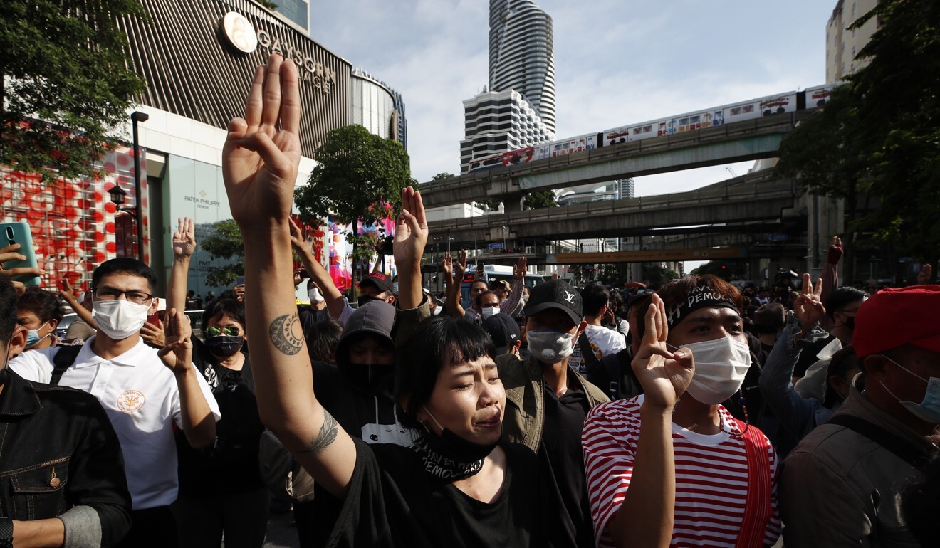 A pro-democracy protester in Bangkok flashes the three-finger salute adapted from the Hollywood movie The Hunger Games. Photo: EPA-EFE