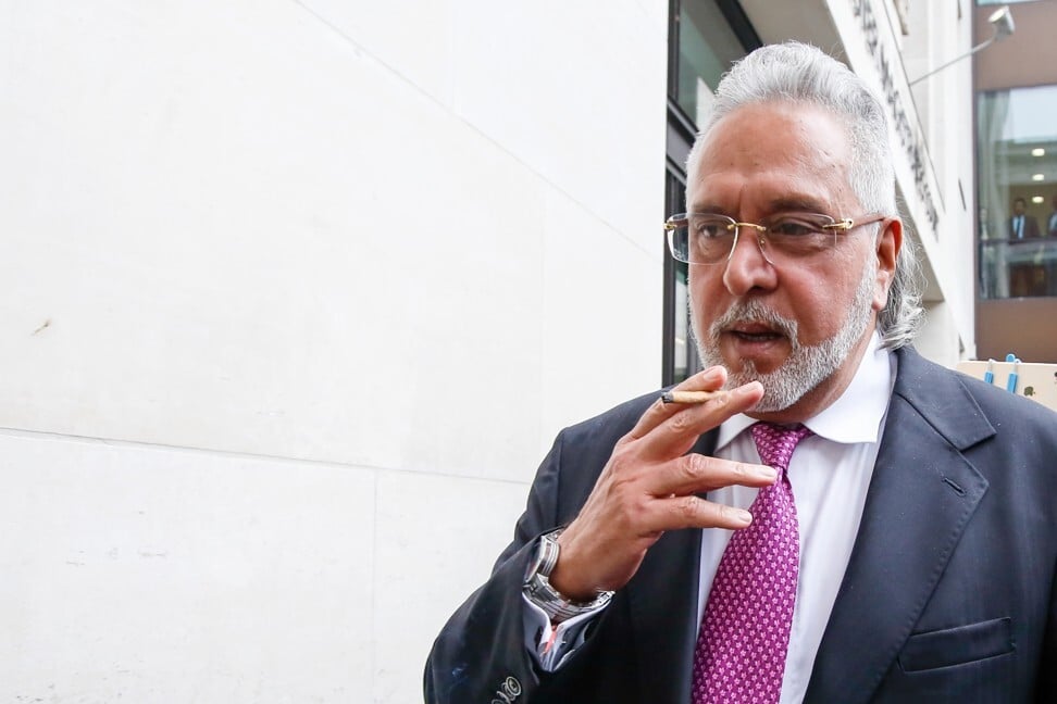 Vijay Mallya, founder and chairman of Kingfisher Airlines Ltd., sparks up as he leaves his extradition hearing at Westminster Magistrates' Court in London in 2018. Photo: Luke MacGregor/Bloomberg