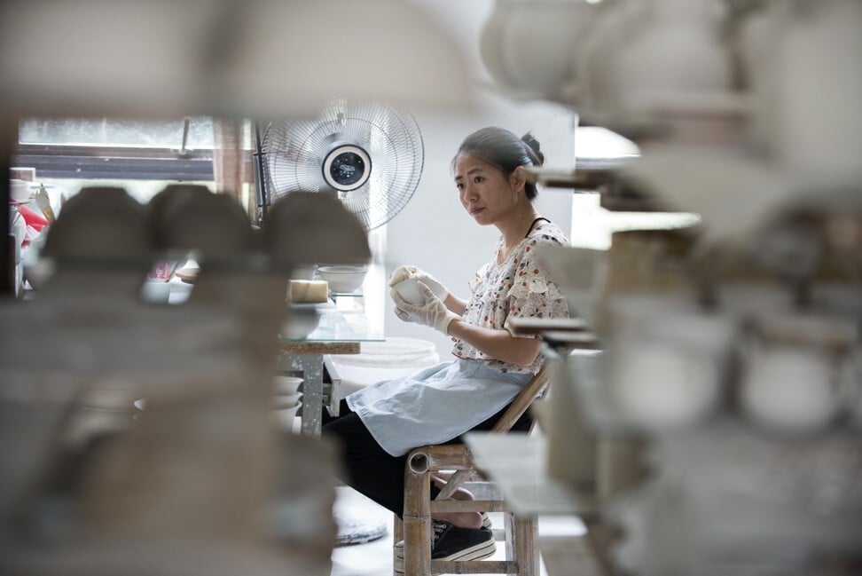 A worker moulds porcelain at the Zhen Rutang factory in Jingdezhen. Photo: Zigor Aldama