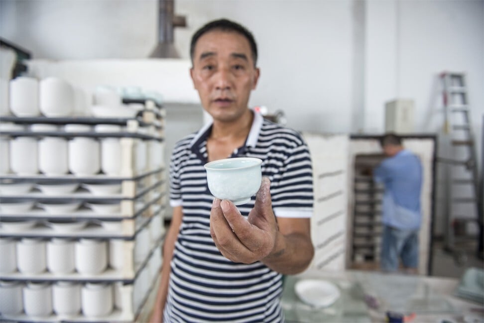 A Jingdezhen worker with a porcelain cup. Photo: Zigor Aldama