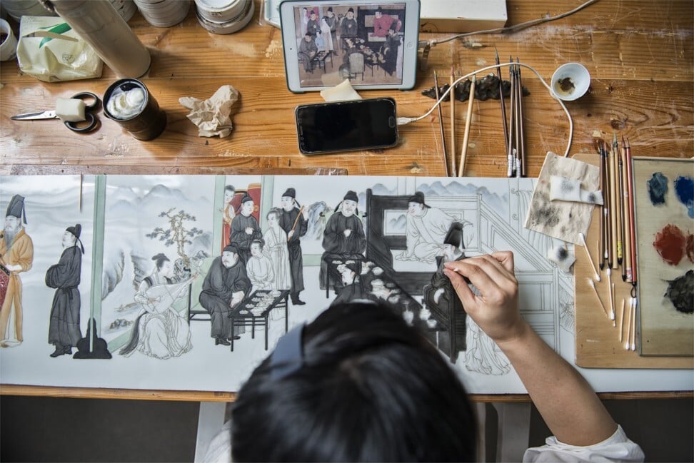 Apprentices as young as 16 copy drawings from their smartphones and tablets and can take several months to complete a piece. Photo: Zigor Aldama