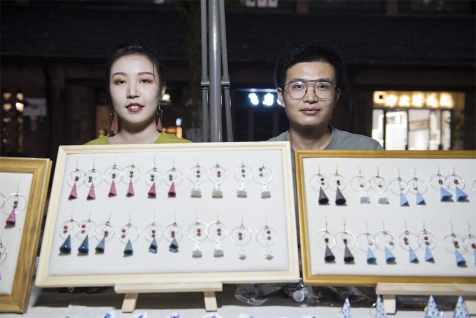 Li Siqi (left) and Ouyang Ningyuan (right) graduated from the Jingdezhen Ceramic Institute in 2018 and 2019, respectively, and now design and produce accessories. Their earrings are a favourite with visitors to the Jingdezhen night market, but the couple barely make ends meet. “Prices are very low because the market is saturated. Often we think of giving up because we don’t even earn enough to eat, but then a big order comes and brings hope again,” Ouyang says. Their aim is to move upmarket and start selling on WeChat. Photo: Zigor Aldama