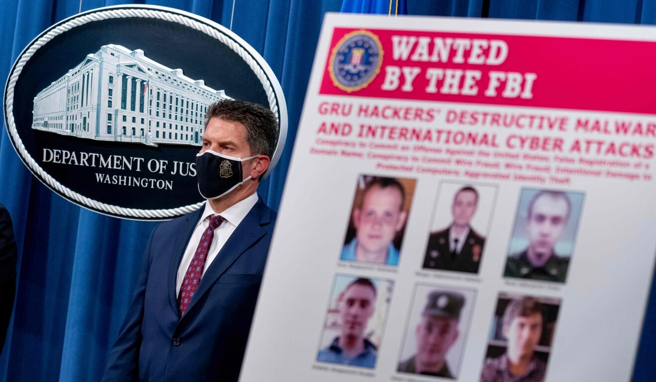 A poster showing six wanted Russian military intelligence officers is displayed as FBI Deputy Director David Bowdich accused six Russian military intelligence officers of carrying out cyberattacks on the 2018 Winter Olympics. Photo: AFP