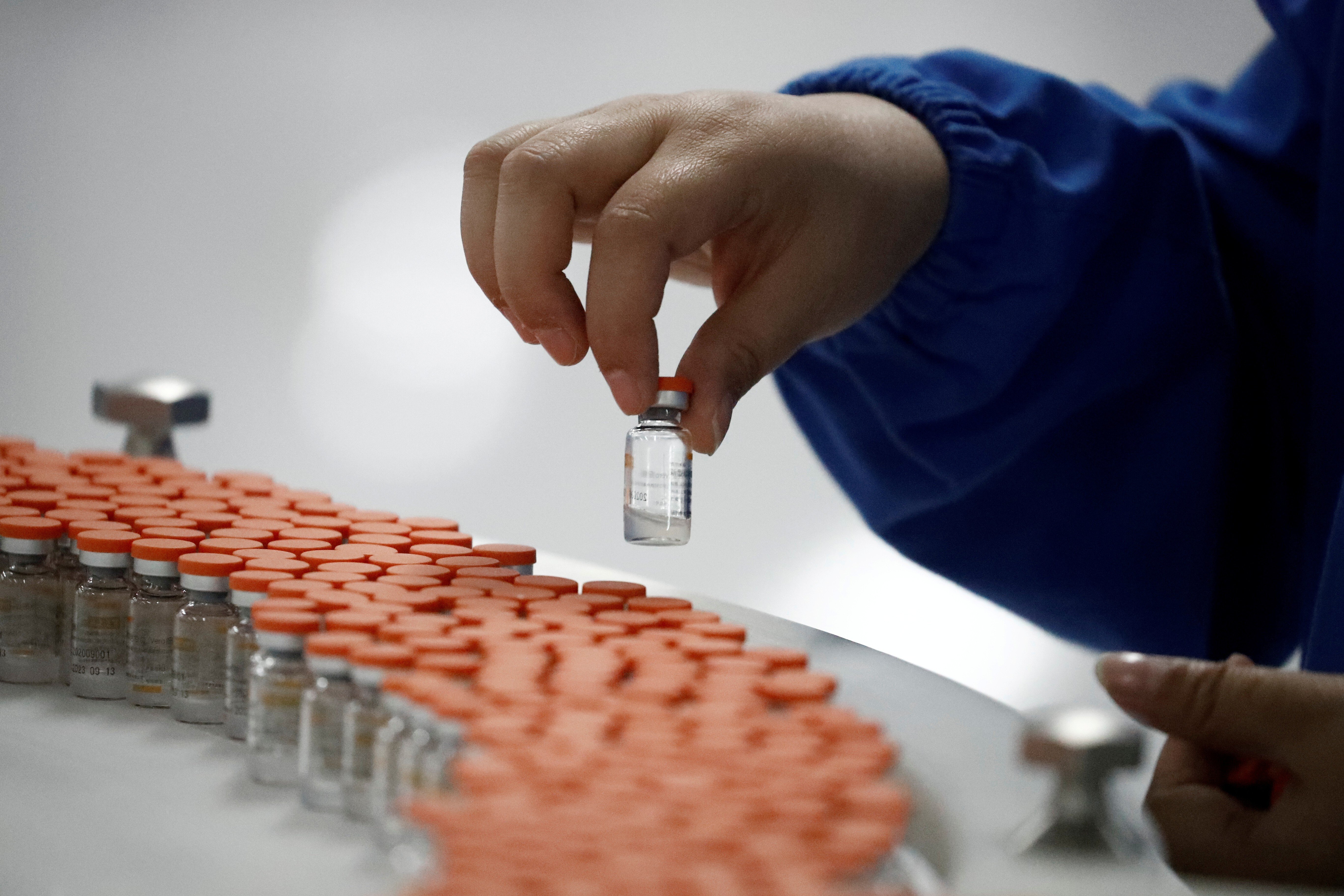 A worker performs a quality check on experimental Covid-19 vaccine vials in the packaging facility of Chinese vaccine maker Sinovac Biotech in Beijing on September 24. China’s success in containing the pandemic and its efforts at vaccine diplomacy afterwards do not appear to have translated into an improved international reputation. Photo: Reuters