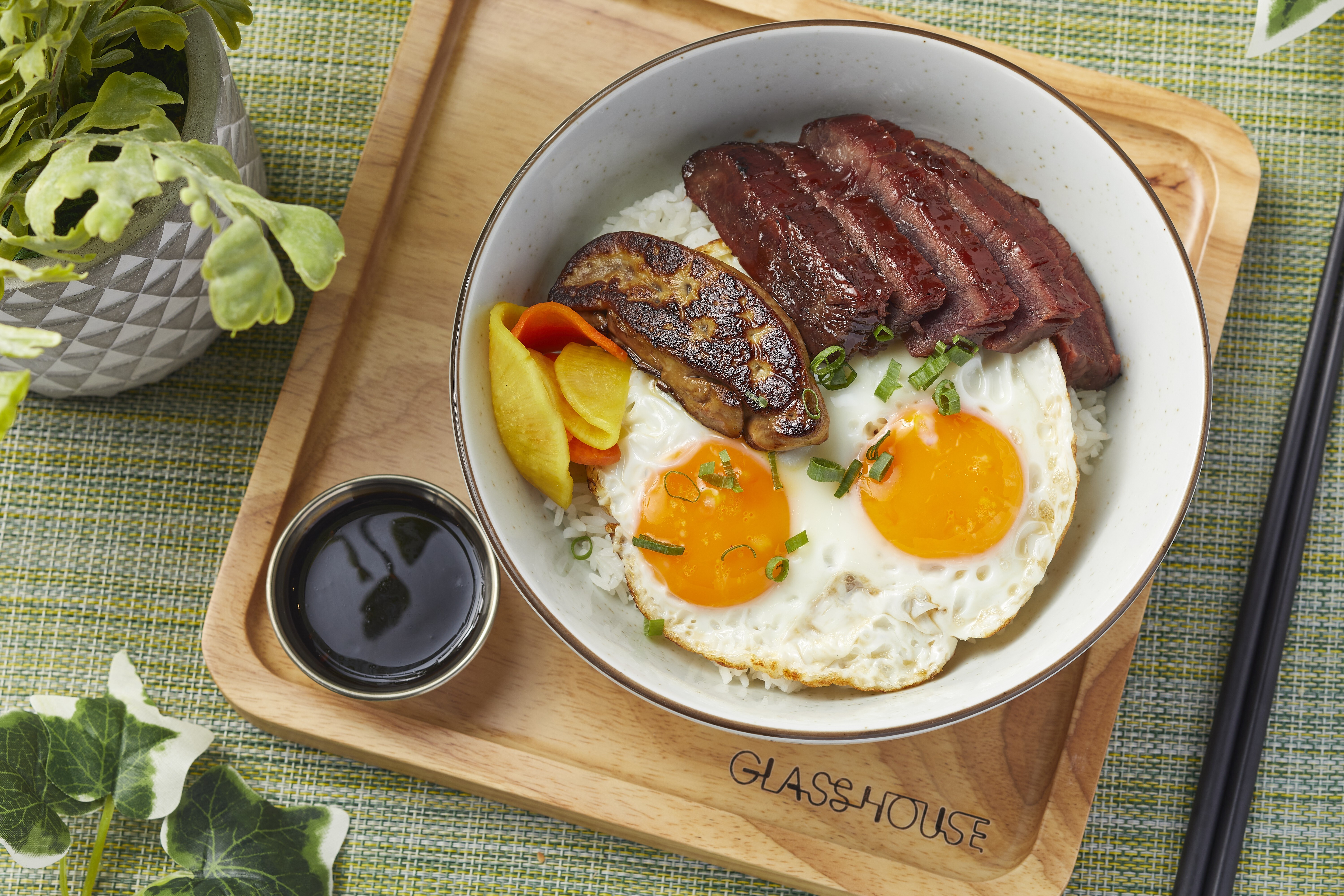 Wagyu char siu and foie gras rice served with fried eggs at Glasshouse Greenery. Photo: handout