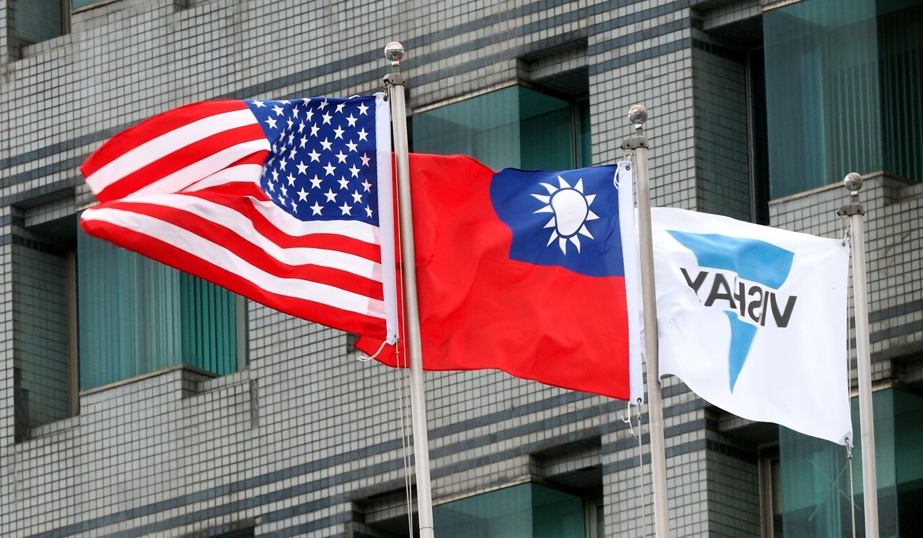 Flags of the US and Taiwan fly side by side at a company in New Taipei City. US support for the self-ruled island could trigger a military clash. Photo: EPA