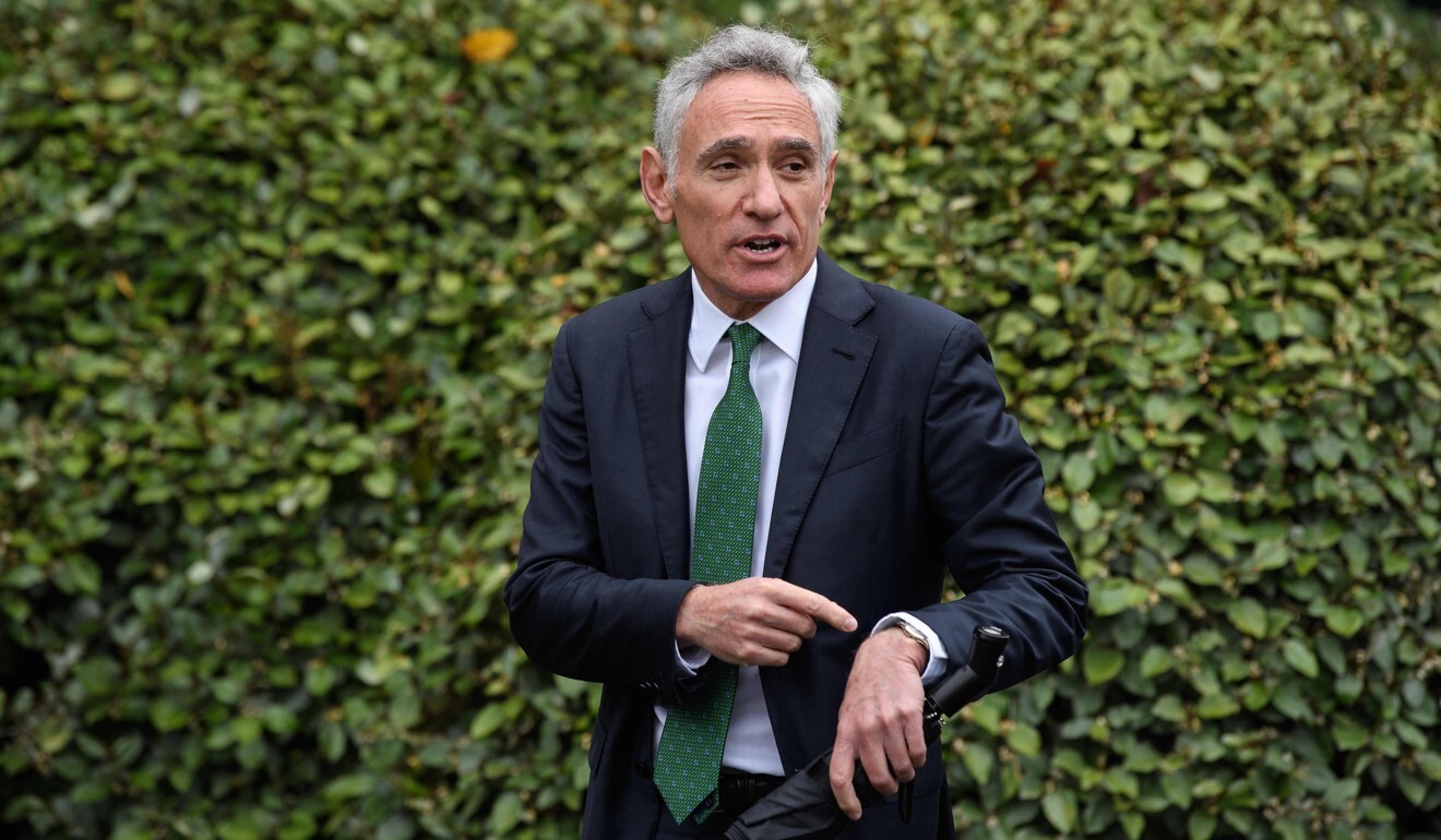 Dr Scott Atlas points to his watch as he walks through the White House’s grounds earlier this month. Photo: AFP