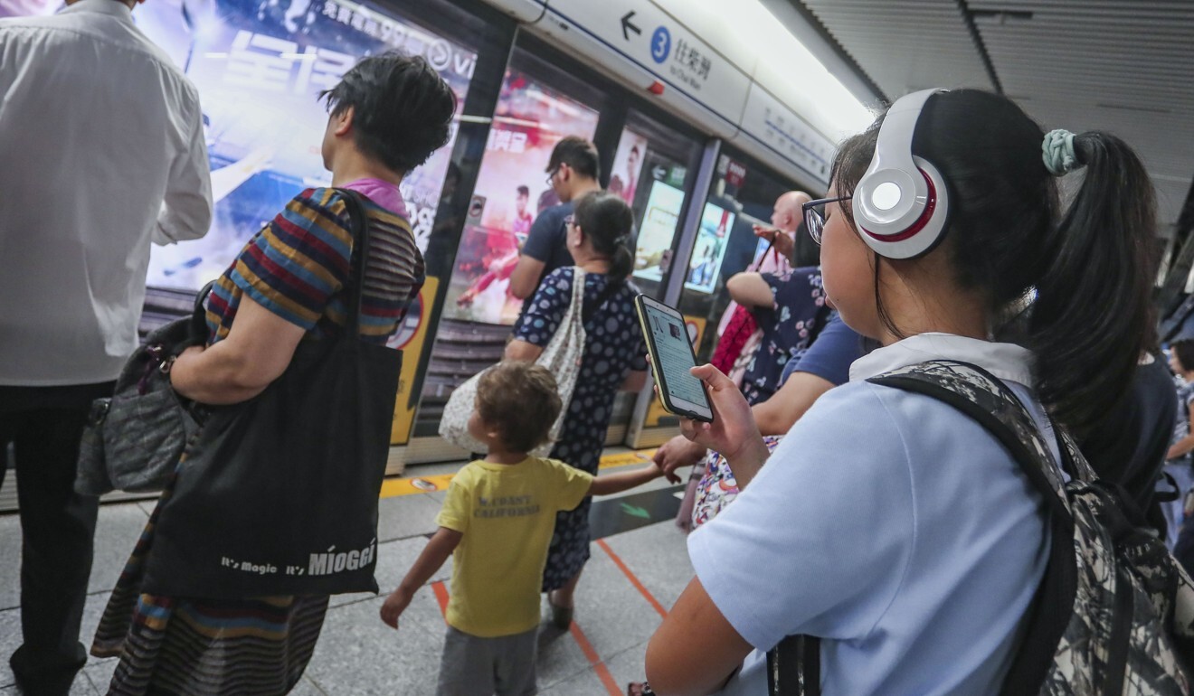 A student on her smartphone on a MTR platform in Hong Kong. Photo: Jonathan Wong