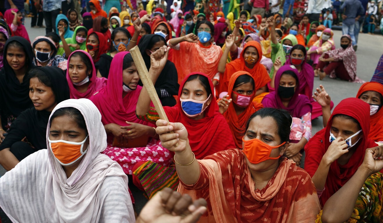 Bangladeshi garment workers shout slogans and block a road during a protest to demand payment of wages. Photo: EPA