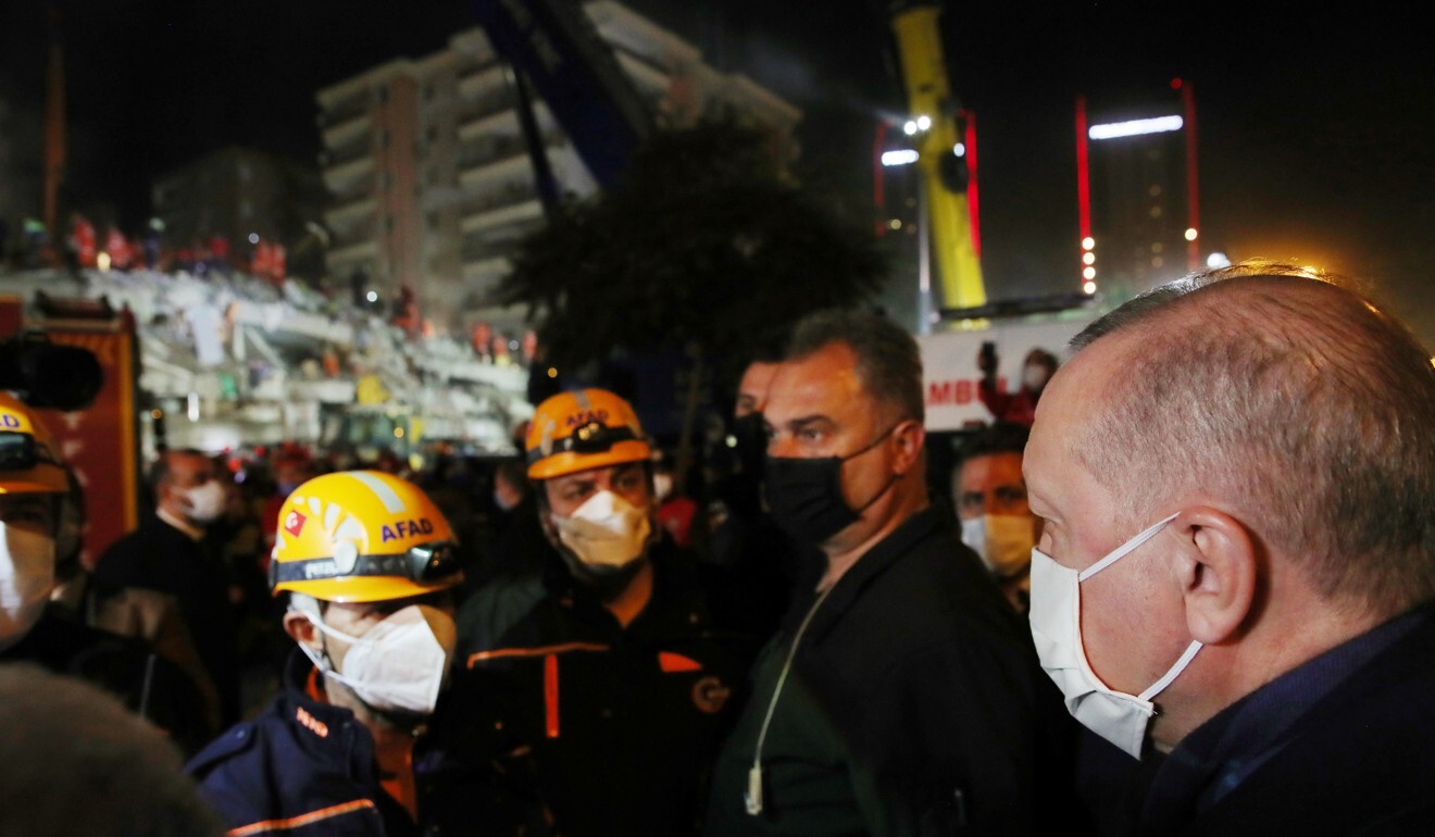 Turkish President Tayyip Erdogan visits the site of a collapsed building after an earthquake in the Aegean port city of Izmir. Photo: Reuters