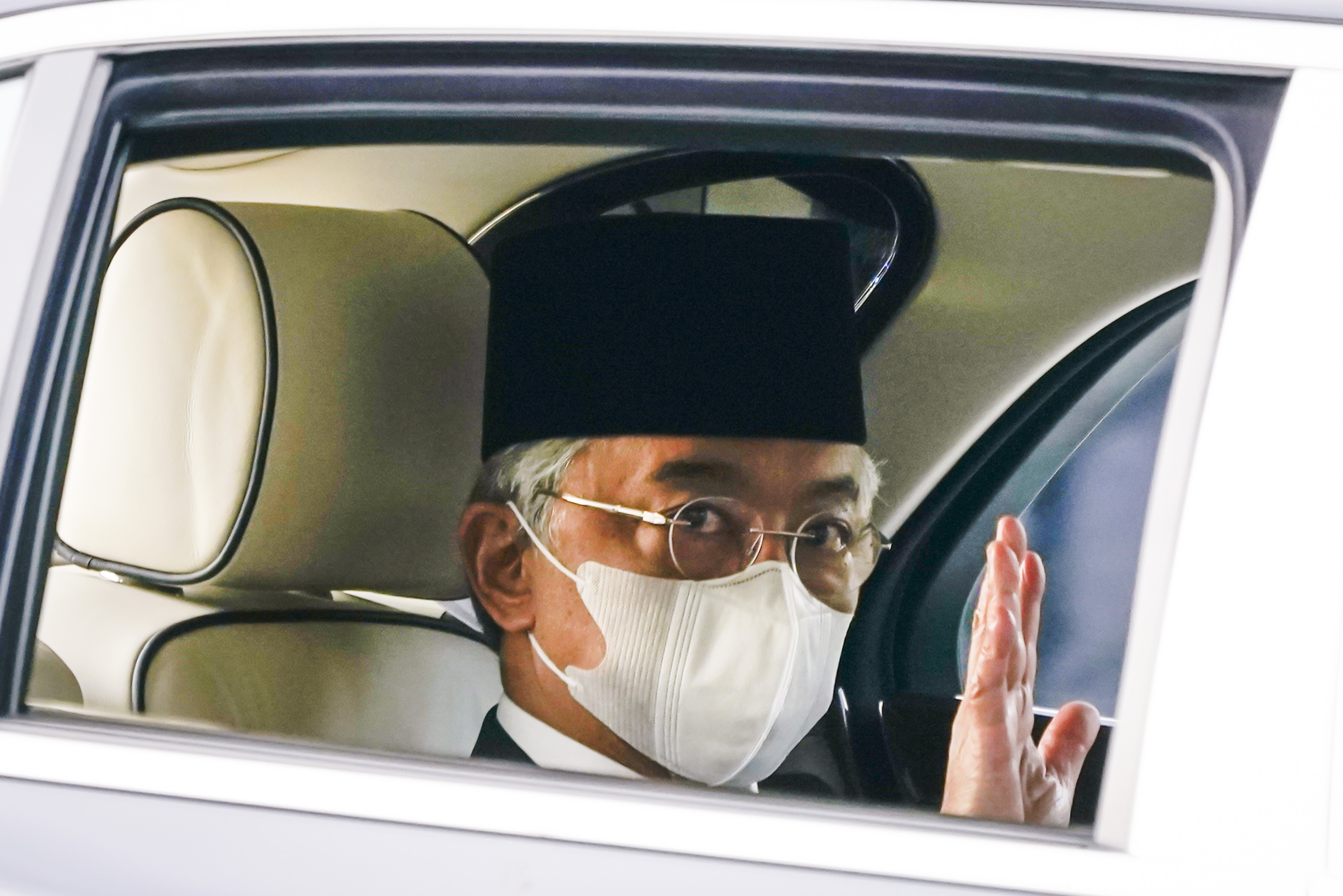 Malaysia's King Sultan Abdullah Sultan Ahmad Shah waves as he leaves the National Palace in Kuala Lumpur. Photo: AP