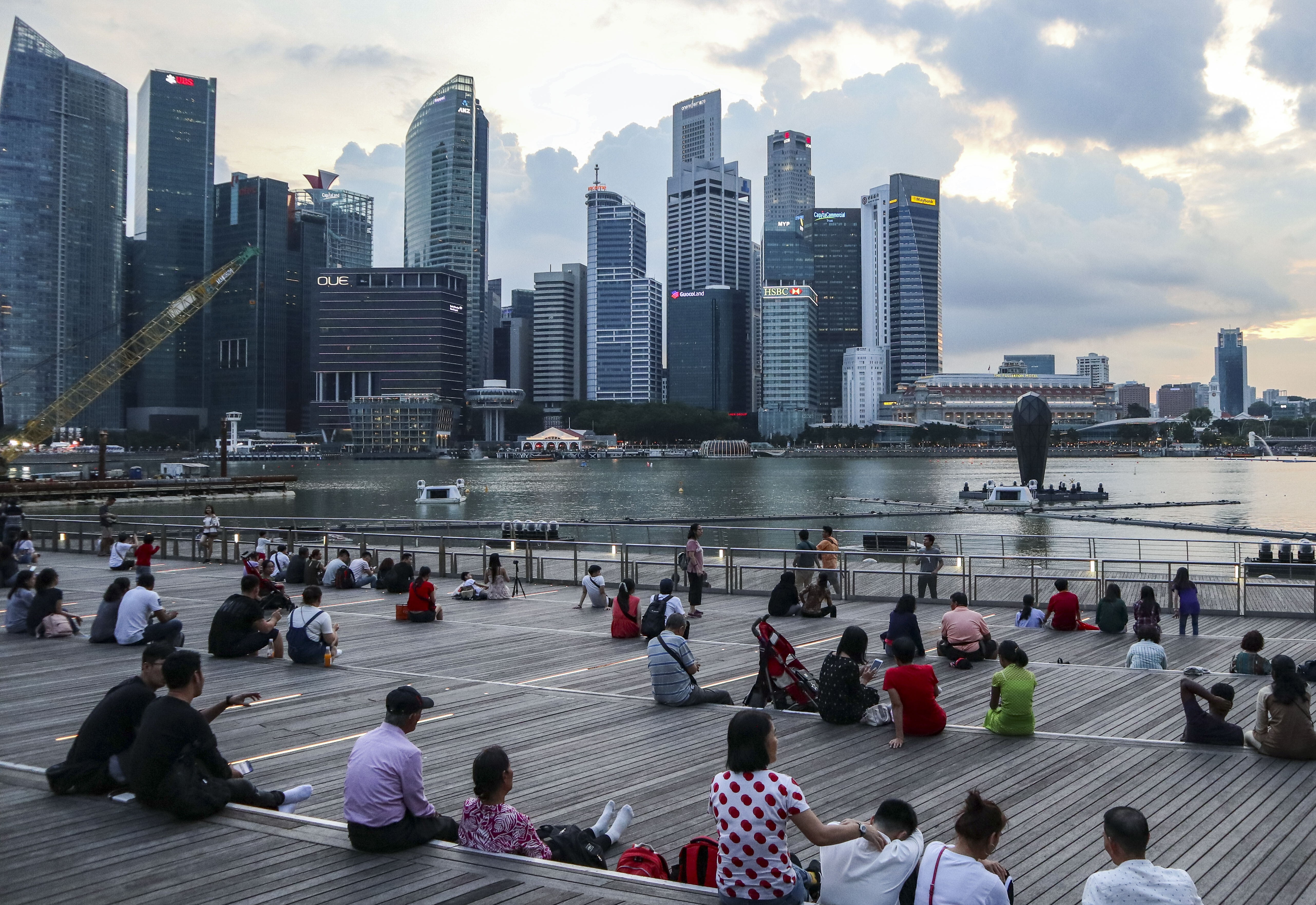 Exterior of the Marina Bay Sands shopping mall where tourists and locals are seen sitting with the Central Business District in in Singapore is seen in the background. Photo: Roy Issa