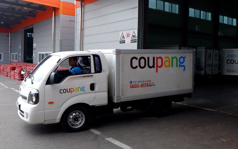 Delivery trucks for e-commerce retailer Coupang leave a distribution centre in Seoul. Photo: Reuters