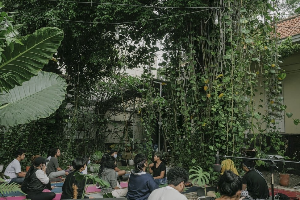 Audience members at Monstera Soundbath, which took place in an area filled with dozens of Monstera deliciosa, or Swiss cheese plants. Photo: Widian Lesmana