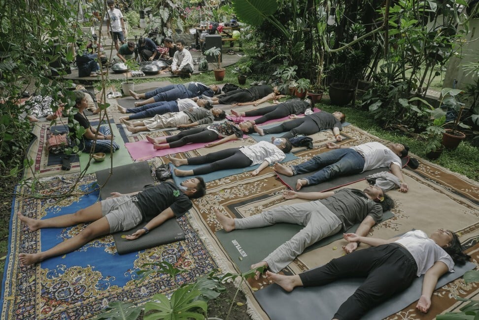Bottlesmoker perform to an audience listening in resting and meditative yoga positions at their Monstera Soundbath concert. Photo: Widian Lesmana