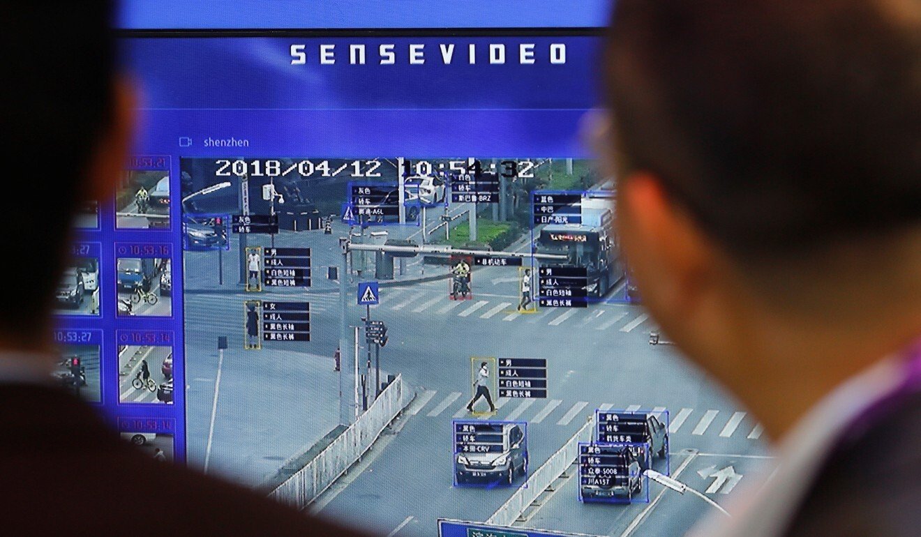 Visitors look at a display demonstrating traffic surveillance at the SenseTime booth at the Security China 2018 exhibition. Photo: Reuters