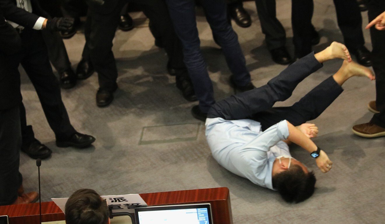 Opposition lawmaker Raymond Chan is seen lying on the floor after his alleged assault by pro-Beijing counterpart Kwok Wai-keung. Photo: Dickson Lee