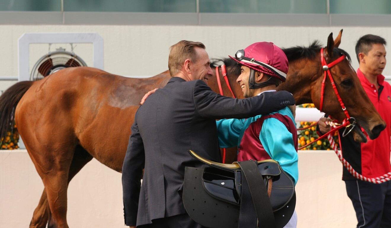 Trainer John Size and jockey Joao Moreira embrace after one of Beat The Clock’s Group One wins.