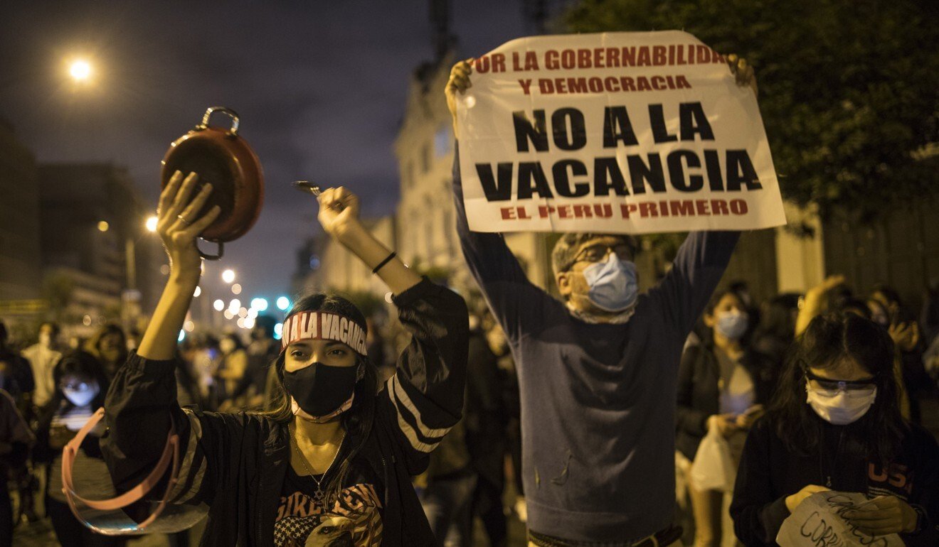 Pro-government protesters gather during a protest near the Congress in Lima, Peru, Monday, Nov. 9, 2020. (AP Photo/Rodrigo Abd)
