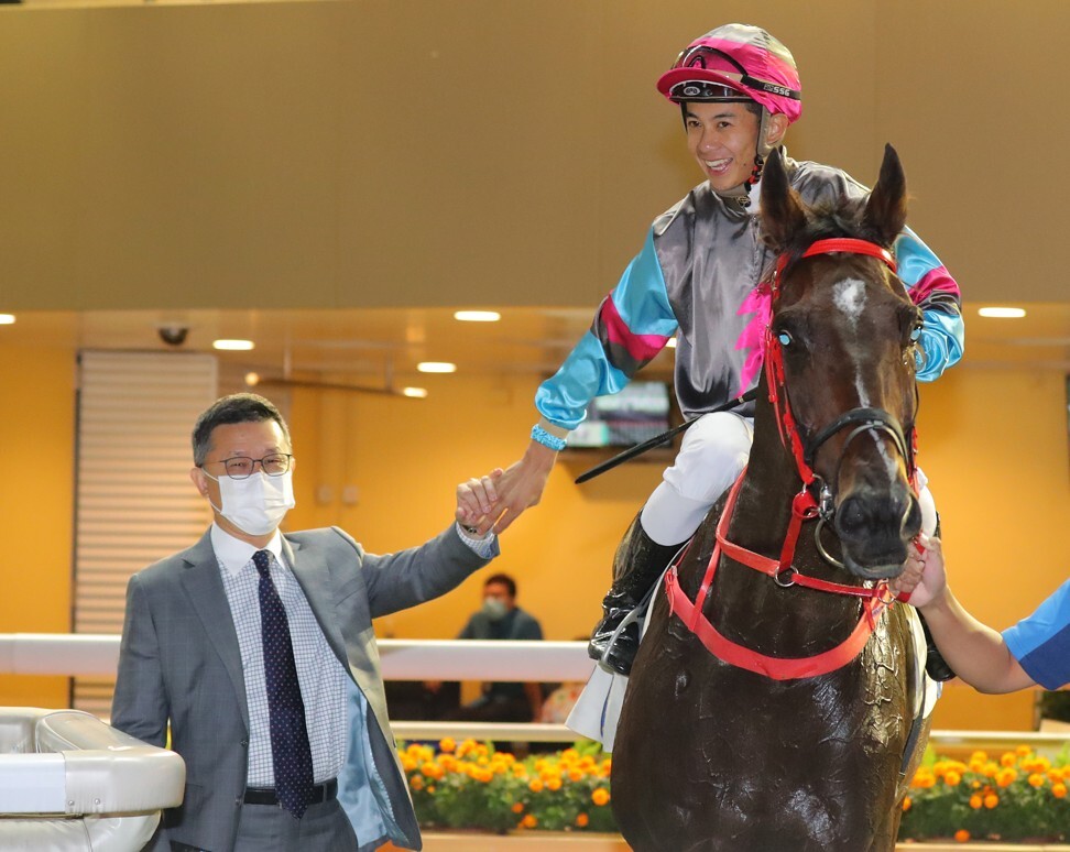 Peter Ho with jockey Derek Leung after winning on Hay Run.