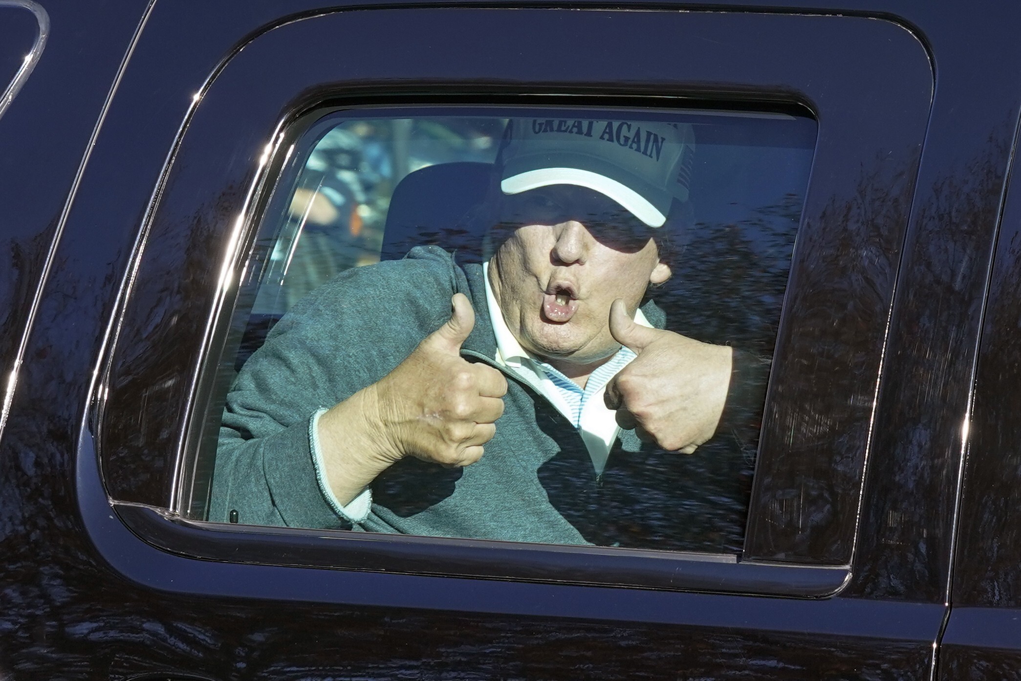 US President Donald Trump gives two thumbs up to supporters as he departs after playing golf at the Trump National Golf Club in Sterling, Virginia. Photo: AP