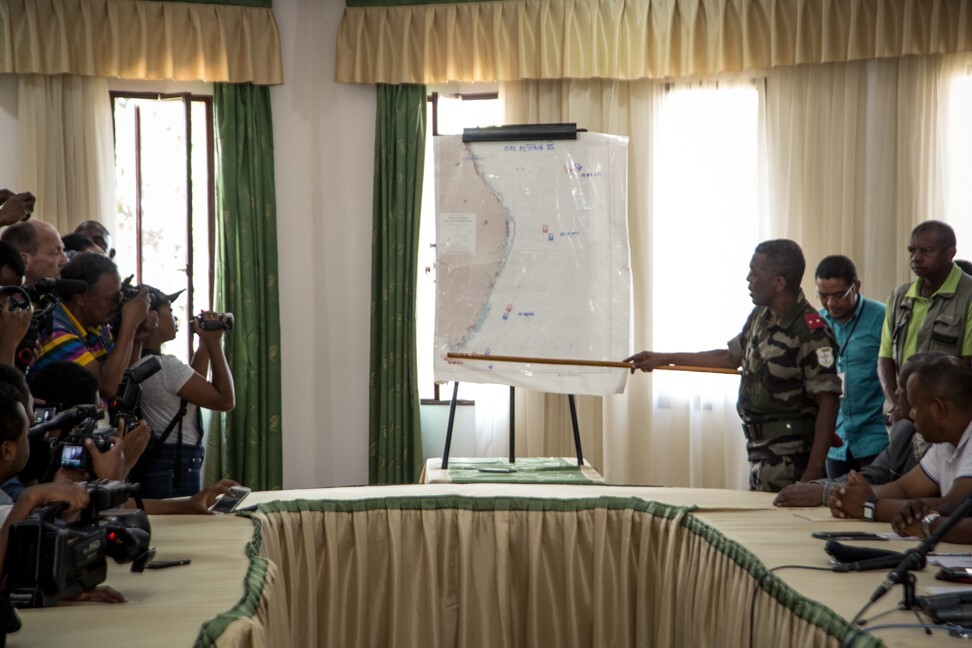 An official of the Ministry of Defence in Madagascar, east Africa, points to a spot on a map showing where a boat was caught in the act of trafficking rosewood. Photo: AFP