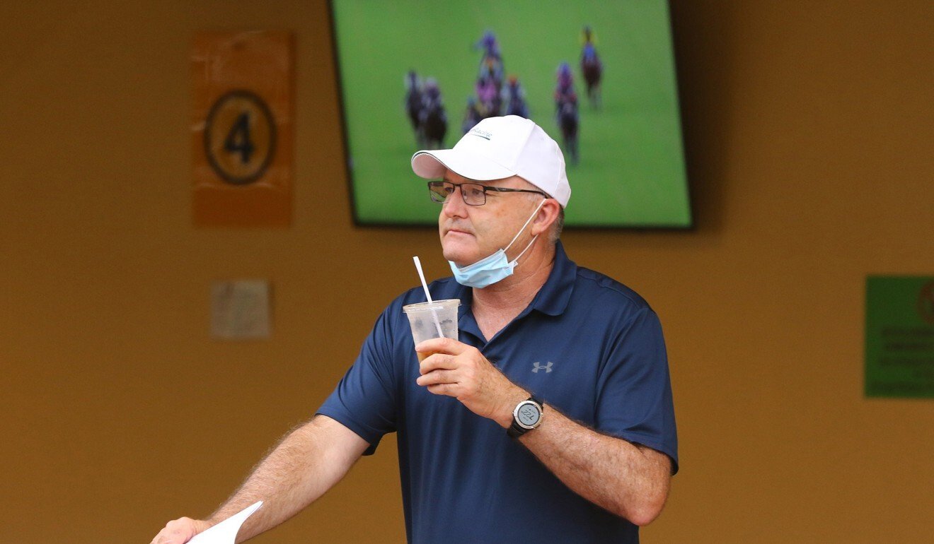 David Hayes watches on as his horses trial at Happy Valley.