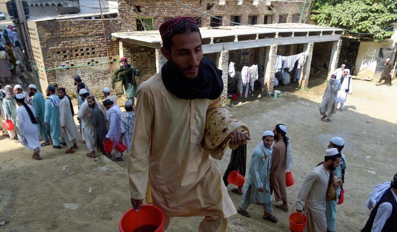 Islamic seminary students wait to collect food at the Darul Uloom Haqqania seminary in Akora Khattak. Photo: AFP