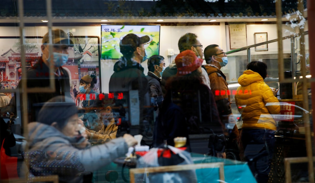 People queue for service at a restaurant on Monday in Beijing. China’s economy is already springing back from the coronavirus pandemic. Photo: Reuters
